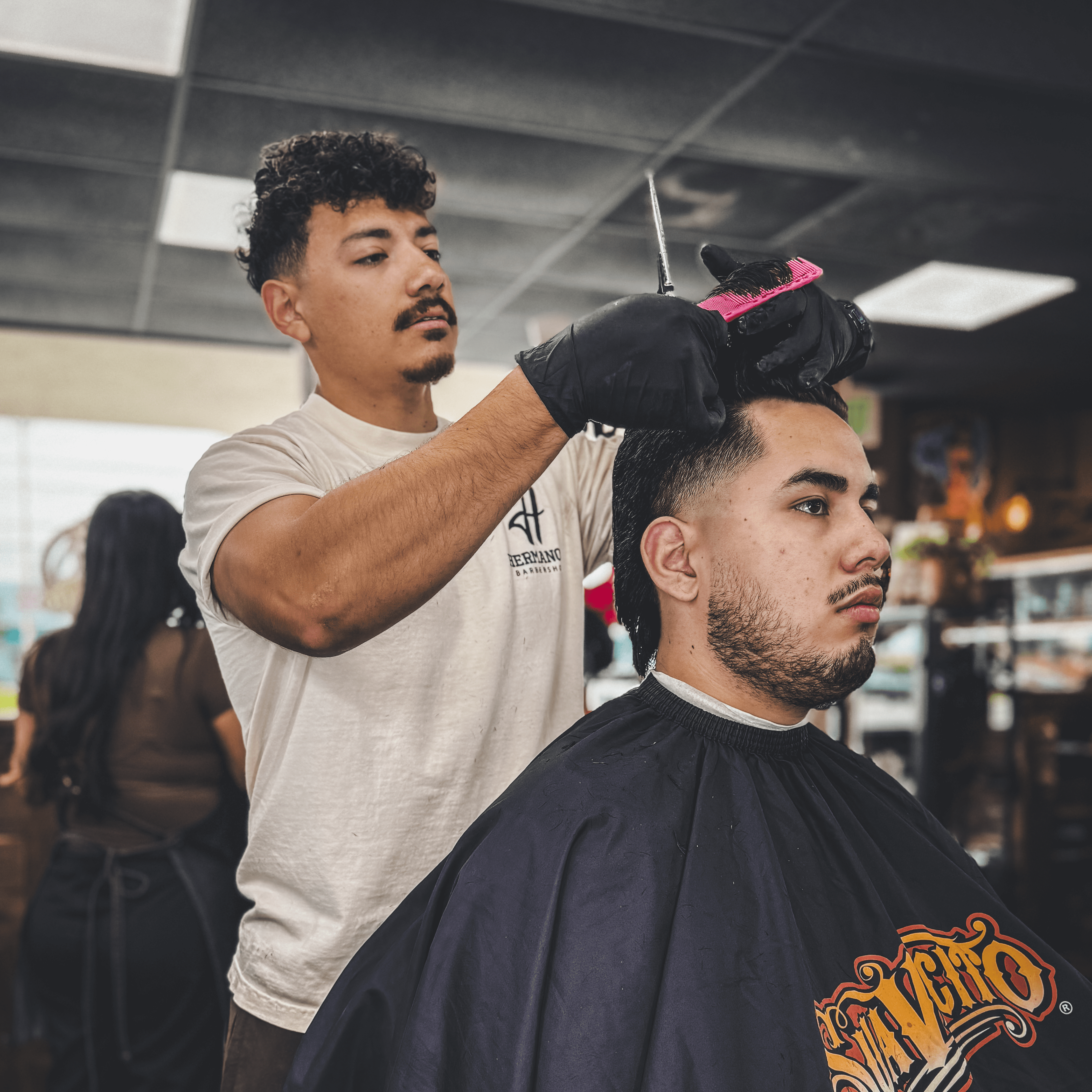 Osiel Campos Jr. giving a modern haircut at Hermanos Barbershop in Cypress, California