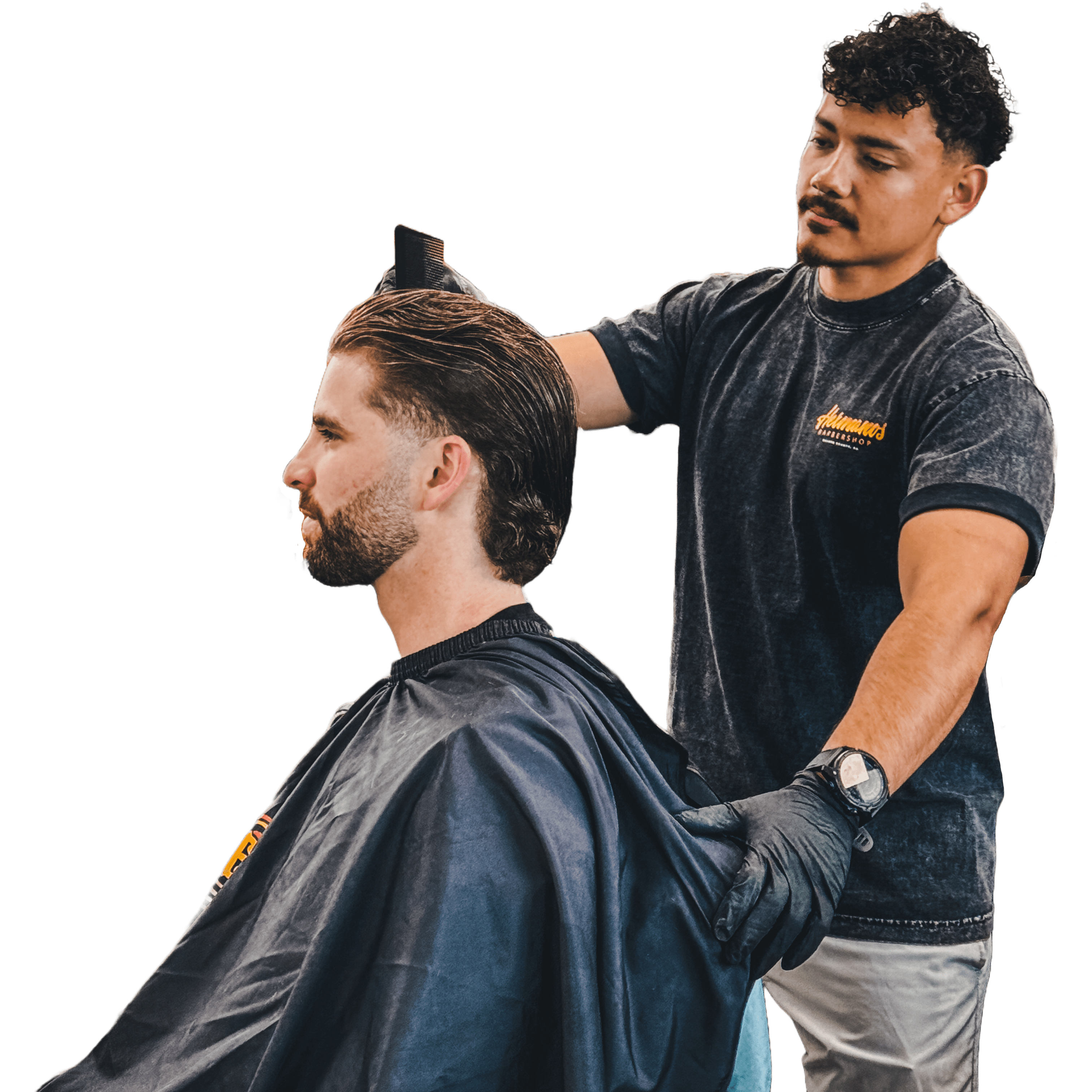 Barber Osiel finishing a clean, styled haircut on a seated client, reinforcing the call to book an appointment.